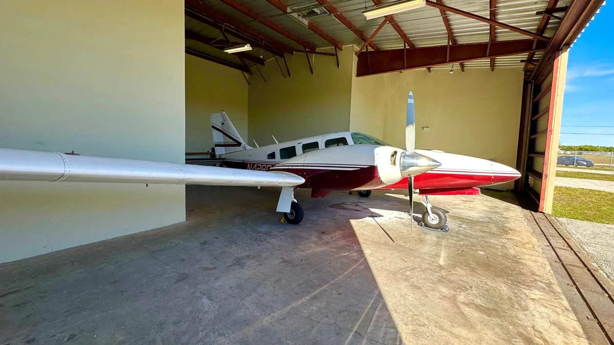 Aeroservice twin-engine training aircraft in the hangar, Miami